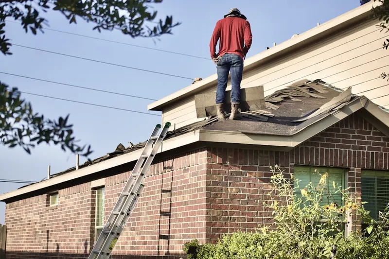 Professional roofer working on a residential roof in Edgewood Meadows